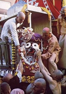 Devotees lift Lord Krishna, in His form as Lord Jagannatha, to His place on His float. San Fransisco, 1975.