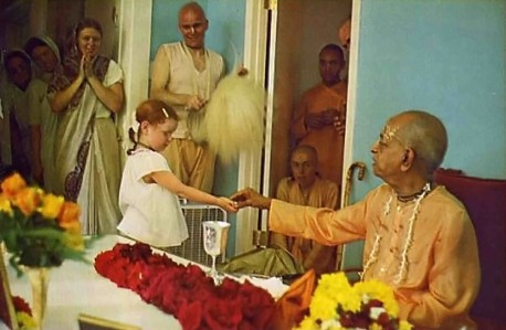 Benediction. Srila Prabhupada, on a visit to Gurukula, hands out sweets to the students.