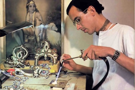 Hare Krishna devotee making jewelery for Radha Krishna deities. 1976.
