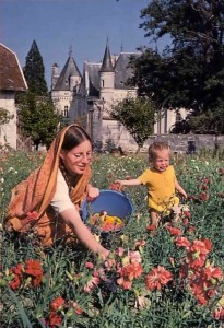 Woman devotee and her son picking flowers at New Mayapur, ISKCON's farm in France.