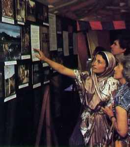 Above, a festival-goer learns of ISKCON's farm projects at one of several photo displays.