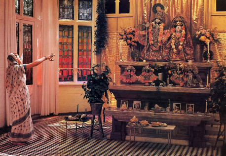 Worship of the Lord's Deity form in the temple is an essential part of bhakti, the yoga of devotion. Here, in an ancient Vedic ceremony called arati, a devotee offers a camphor lamp to the Deities of Lord Krsna and His eternal consort. Srimati Radharani, who grace the altar at the Bhaktivedanta Manor near London.