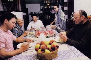 At dinner: Marco and his wife, father, and mother share sanctified food with guests.
