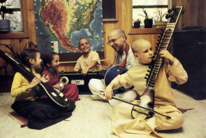 Singing to glorify Krsna, Bhurijana and the children accompany themselves with traditional Indian instruments