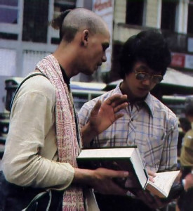 A devotee in Brazil distributes a Portuguese translation of a book by Srila Prabhupada.