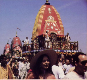 Festive summer crowds escort Lord .Krsna's chariot along Venice Beach in Los Angeles, California