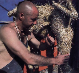 A figure takes shape under the skillful hands of Bhaktisiddhanta dasa, working here in Los Angeles in 1976. To create the figure, he uses the traditional Indian method of puttala, constructing a base of straw upon which he will mold the final form in clay.