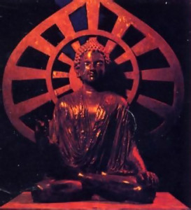 A figure of Lord Buddha they created sits under an ornate gazebo.
