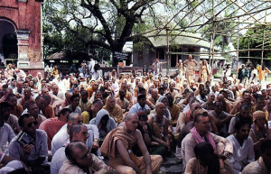 At the birthsite of Lord Caitanya, devotees listen attentively to a discourse on the Lord's mission in the material world. The tree under which Lord Caitanya took birth is in the background.