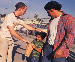 ln downtown San Diego, an appreciate father and son receive government surplus from an ISKCON representative.
