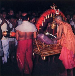 Using a gold palanquin, priests carry the ursava (festival) Deity from the temple shrine to Car Street.