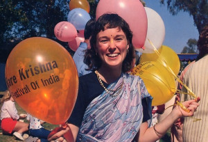 A festival hostess passes out souvenir balloons