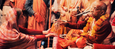 Spiritual life begins with initiation by a bona fide spiritual master. Here, His Divine Grace A C. Bhaktrvedanta Swami Prabhupada accepts an aspiring devotee as his disciple. The initiate receives sacred beads and vows to chant the Hare Krsna maha-mantra a prescribed number of times daily.