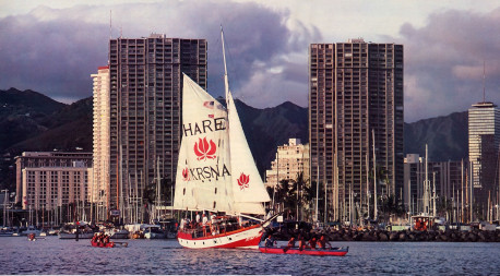 Traditional Hawaiian outriggers flank the Jaladuta II as she leaves the Honolulu harbor for an evening cruise