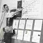 A child at Gurukul learns how to read--and how to be Krishna conscious. ISKCON 1974.