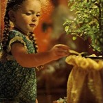 Nandini dasi waters the tulasi, Lord Krishna's favorite plant. ISKCON Gurukul Dallas Texas 1975.