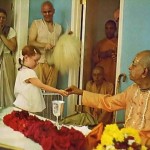 Benediction. Srila Prabhupada, on a visit to Gurukula, hands out sweets to the students.