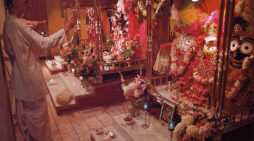 A pujari (priest) makes an offering to the Deity of Lord Jagannatha at an ISKCON temple. 1975. Whose Worship is Idol Worship?