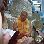 Prabhupada sitting on Vyassasana in Airport speaks with press. 1975.