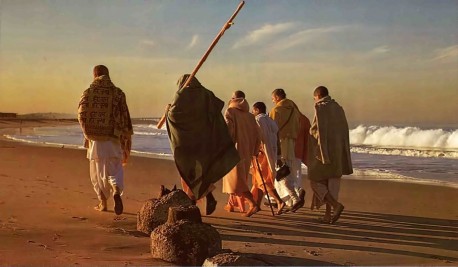 Srila Prabhupada and disciples walking off into sunrise. Venice Beach, CA, 1975.