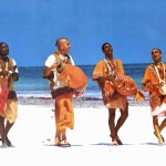 Pioneers of the Krishna consciousness movement in Africa chant Hare Krishna on the beach at Mombasa, Kenya. 1974.