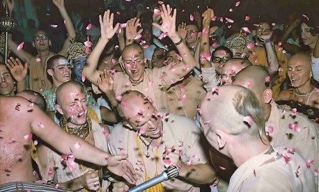 Shower of flower petals rains down as enthusiastic devotees fill the temple with Krishna's holy names. Krishna Balarama Temple Opening. 1976.