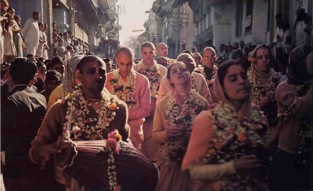 Garlanded by the townspeople, American devotees of Krishna chant His holy names in Surat. 1976.