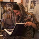 Miriam Briks (Dhrti-devl dasi) refers to a book on Flemish artists to get technical hints for her painting.