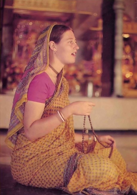 Female Hare Krishna Devotee Sitting in Temple Chanting Hare Krishna on Japa Beads - 1977
