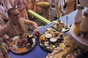 A devotee offers the first plates to Lord Krsna