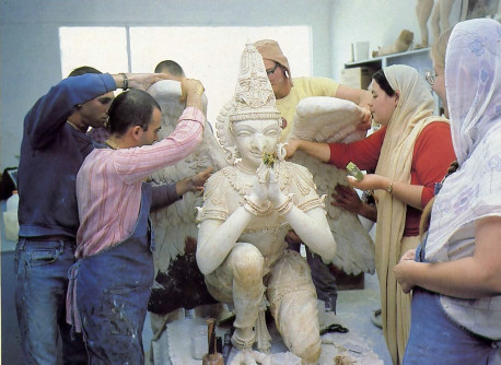 Devotional arts around the world. Devotees of Krsna collaborate on a sculpture of Garuda, the eagle carrier of Lord Visnu