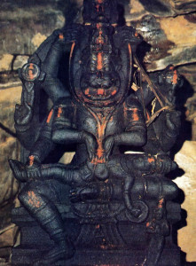 Nrsimhadeva holds on His lap and claws apart the demonic King Hiranyakasipu