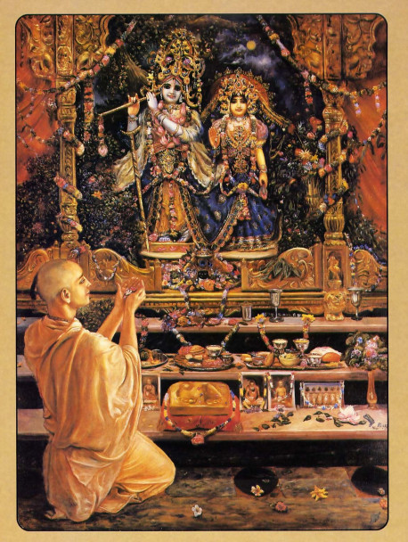 In the temple of Lord Krsna, a devotee presents an offering to the Lord and His eternal consort Radharani.