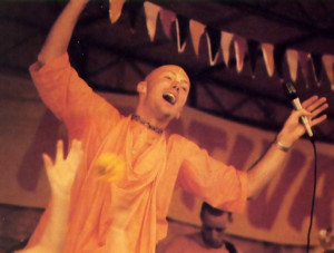 Leaping in ecstasy, the irrepressible Dhrstadyumna Swami leads a number as flowers fly