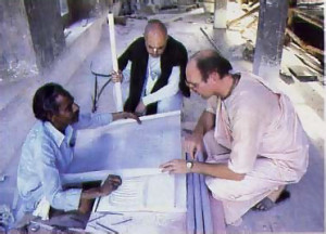 At the Srila Prabhupada memorial under construction on the temple grounds, he consults with his chief assistant, Bhaktisiddhanta dasa (wearing black shawl) and an Indian artisan.