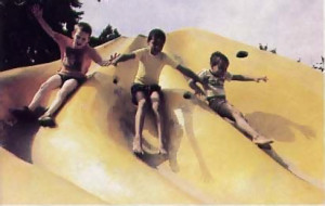 the boys have a ball on a slide near the school
