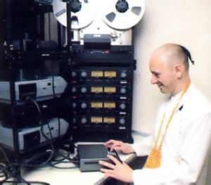 Ameyatma dasa, who designed the electronics of FATE's computerized multimedia exhibit operates a bank of synchronized slide projectors.