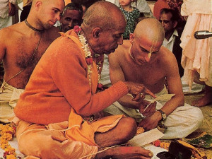 Srila Prabhupada instructs Yaduvara dasa in the pronunciation of the sacred Gayatri mantra after awarding him second, or brahminical, initiation.