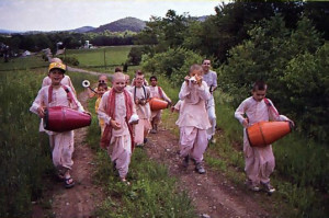 Haridasa (second from right) leads the boys on one of their regular sankirtana outings to the covered bridge