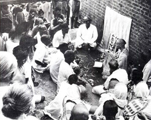 His holiness Acyutananda Maharaja, a disciple of His Divine Grace A.C. Bhaktivedanta Swami Prabhupada, lectures daily to a large gathering of people at a bathing ghat on the Ganges River.