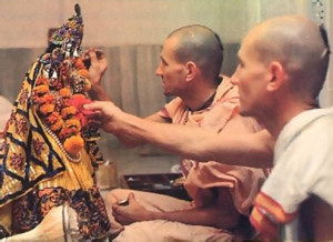 In the privacy or the altar room the brothers devotedly decorate RadhaMadhava in the early morning.