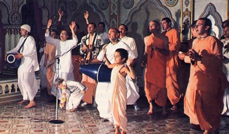 The congregational chanting and dancing as their elders chant HareKrsna to the accompaniment of drums and hand cymbals.